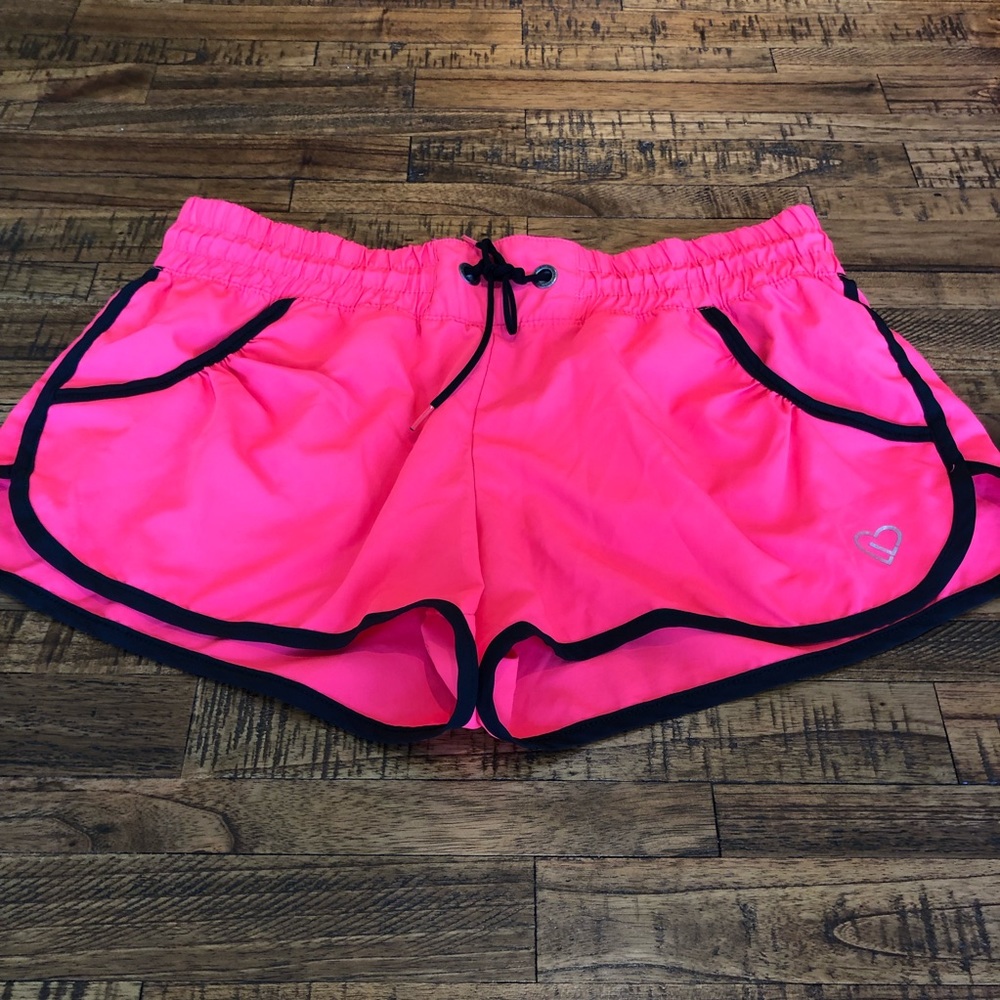 Neon pink athletic shorts with pockets